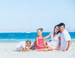 Family of four on tropical beach