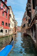 Photo: Gondola on canal between old houses at Venezia - Italy Gondola on canal between old houses at Venezia - Italy