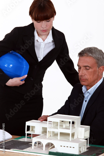Photo: Architects looking at model of building Architects looking at model of building