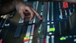 Man in sound studio working with sound mixer console