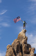 Waving a flag on the summit.
