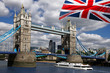Tower Bridge with boat and  flag of England in London