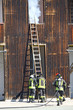 Firefighters extinguish a fire with white smoke in their fire st