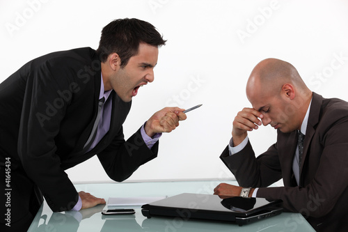 Photo: Businessman screaming at a colleague Businessman screaming at a colleague