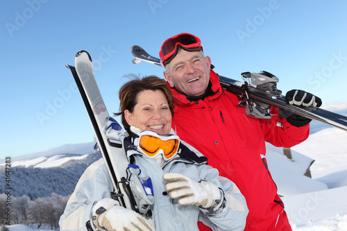 Photo: Retired couple having fun on a skiing trip Retired couple having fun on a skiing trip