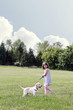 Photo: Little Girl Walking her Puppy Little Girl Walking her Puppy