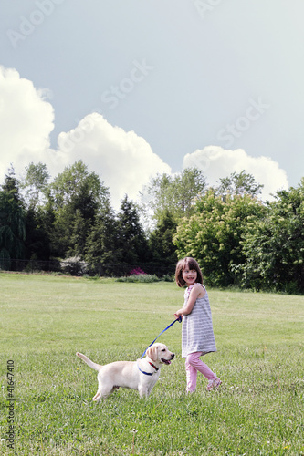 Photo: Little Girl Walking her Puppy Little Girl Walking her Puppy