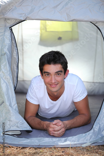 Photo: Boy lying in tent Boy lying in tent