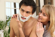 Man shaving in his bathroom