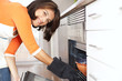 Woman opening the kitchen oven