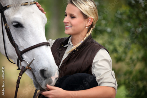 Photo: Young lady stroking her horse Young lady stroking her horse