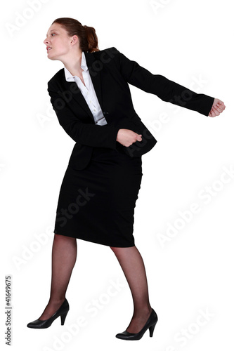 Photo: Businesswoman pulling an invisible chain Businesswoman pulling an invisible chain