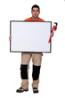Man with a wrench and a board left blank for your message