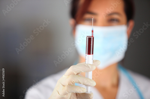 Photo: Woman taking blood sample Woman taking blood sample