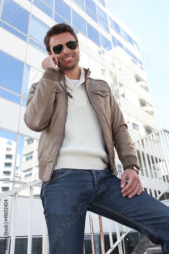 Photo: Trendy man making call in the city Trendy man making call in the city