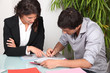 Businesswoman helping her client fill in paperwork