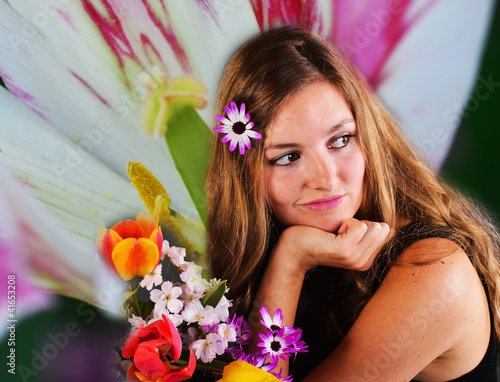 Photo: Springtime: young, pretty woman with colorful spring flowers Springtime: young, pretty woman with colorful spring flowers