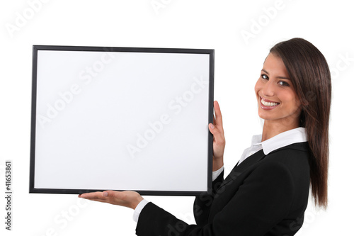 Photo: Young woman holding a publicity poster Young woman holding a publicity poster