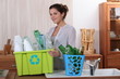 Brunette recycling empty bottles