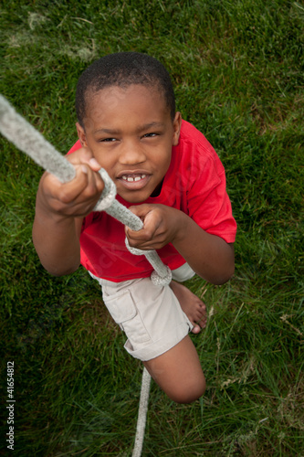 Photo: Boy climbing a rope Boy climbing a rope