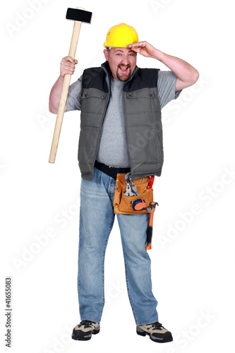 Photo: Man with sledge hammer tired after hard day Man with sledge hammer tired after hard day