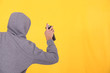 Man in a hoodie spray painting