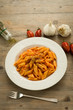 Penne pasta cooked with tomato sauce, garlic and oregano