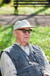 Senior happy man sitting in the park