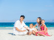 Family of four on tropical beach Family of four on tropical beach