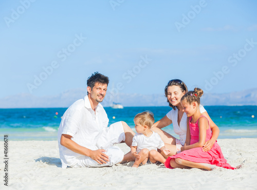 Photo: Family of four on tropical beach Family of four on tropical beach