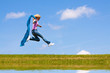 Woman jumps on the meadow