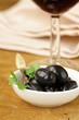 Pickle black olives in a bowl on a wooden table