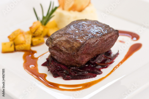 Photo: Fillet steak sitting over red braised cabbage Fillet steak sitting over red braised cabbage