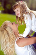 Foto: Mother playing with her daughter in the park Mother playing with her daughter in the park