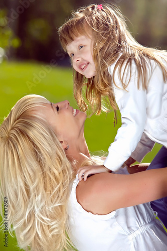 Photo: Mother playing with her daughter in the park Mother playing with her daughter in the park