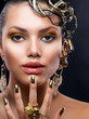 Golden Makeup and Jewelry. Fashion Model Portrait