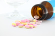 Tablet medicine from bottle on desk.