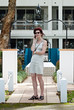 Attractive woman using phone at apartment entrance Attractive woman using phone at apartment entrance