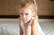 sad child sits on the bed