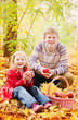 brother and sister in autumn garden