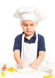 Beautiful caucasian boy making a cake