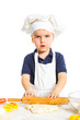 Beautiful caucasian boy making a cake