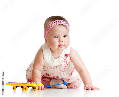 Foto: little child girl playing musical toy little child girl playing musical toy