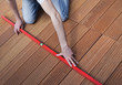 Man using spirit level on the floor