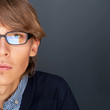 Portrait of young man with smart and wise look. Looking at camer