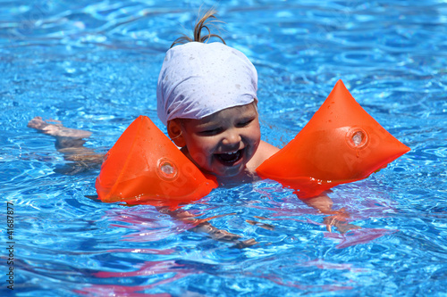 Photo: Toddler girl with swimmies in pool Toddler girl with swimmies in pool