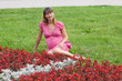 A pregnant woman (9 months) rests in a park