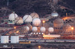 Storage tanks of an oil refinery illuminated at night Storage tanks of an oil refinery illuminated at night