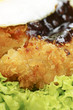 Close-up of deep fried chicken with salad and egg