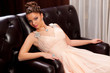 woman in a long sitting on the couch